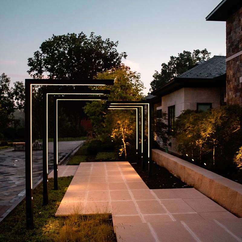 Front stone walkway featuring stone wall and modern lighting